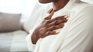 Picture of a lady with her right hand resting across her chest